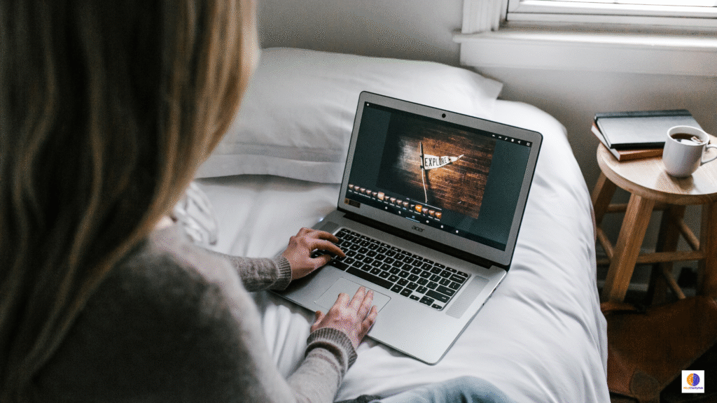 Woman sitting in bed at night using a MacBook Pro, illustrating the hidden costs of screen time on sleep, focus, and brain health