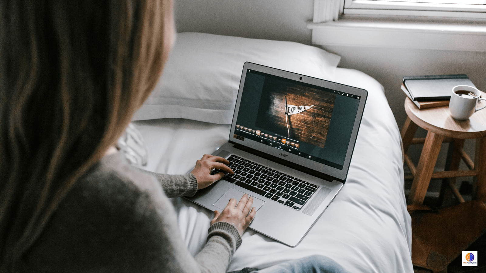 Woman sitting in bed at night using a MacBook Pro, illustrating hidden costs of screen time on sleep and brain health