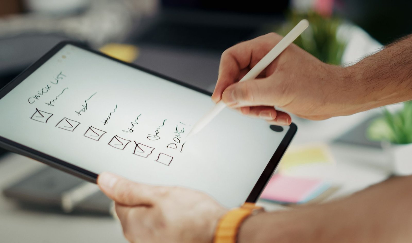 Declutter photos with quick album rules Reviewing a digital declutter checklist while organizing photos and documents on a tablet.