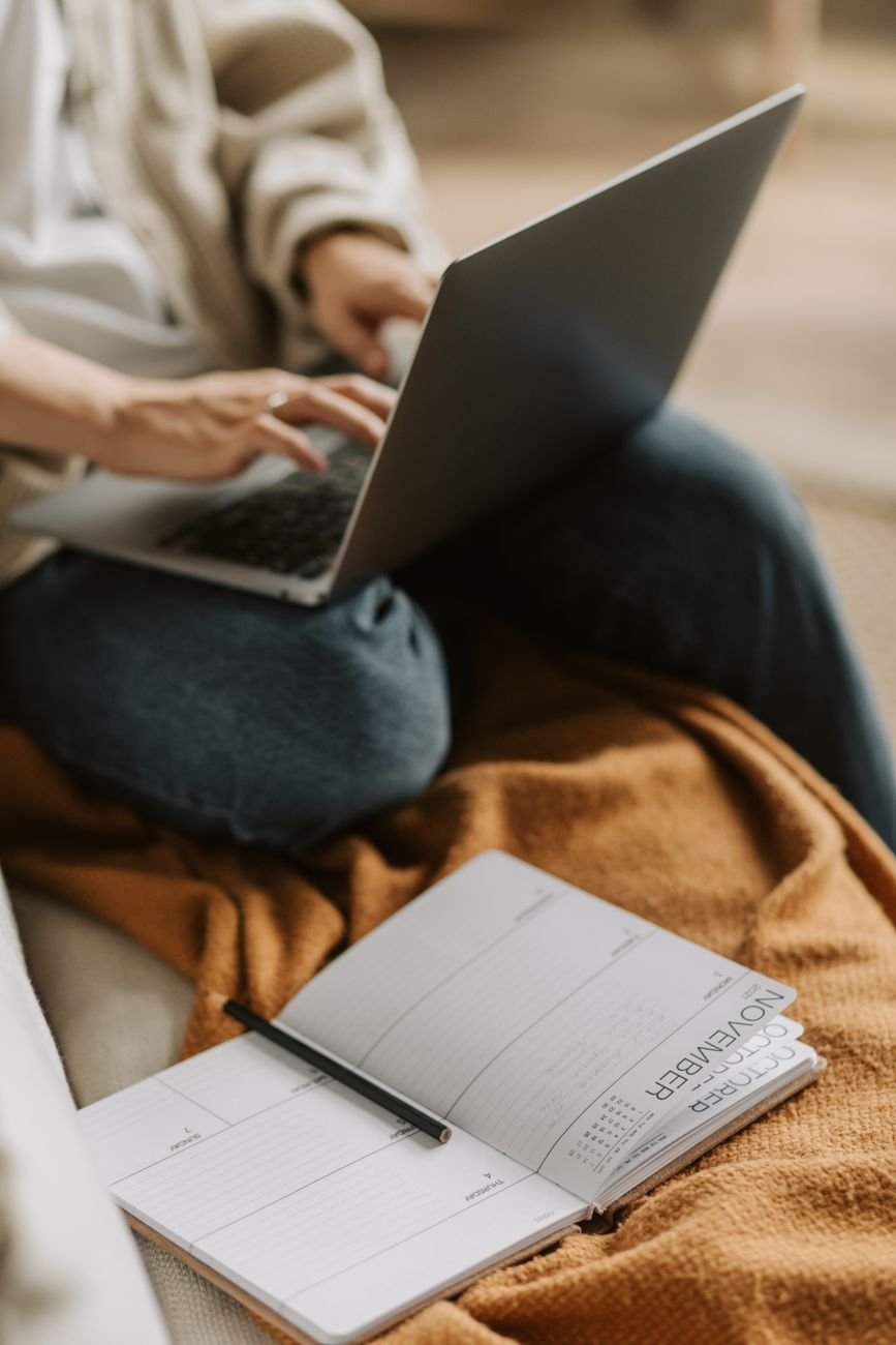 Planner and laptop setup for a focus routine for remote work, supporting daily planning and clean shutdown habits.