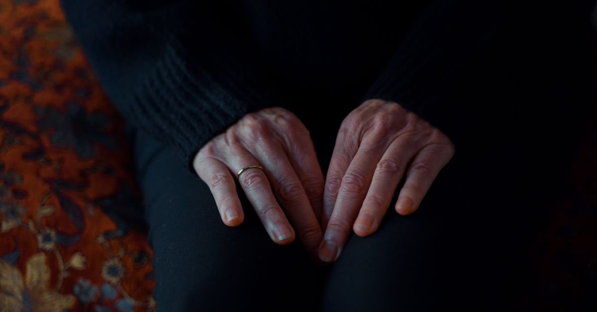 Hands resting loosely on a lap