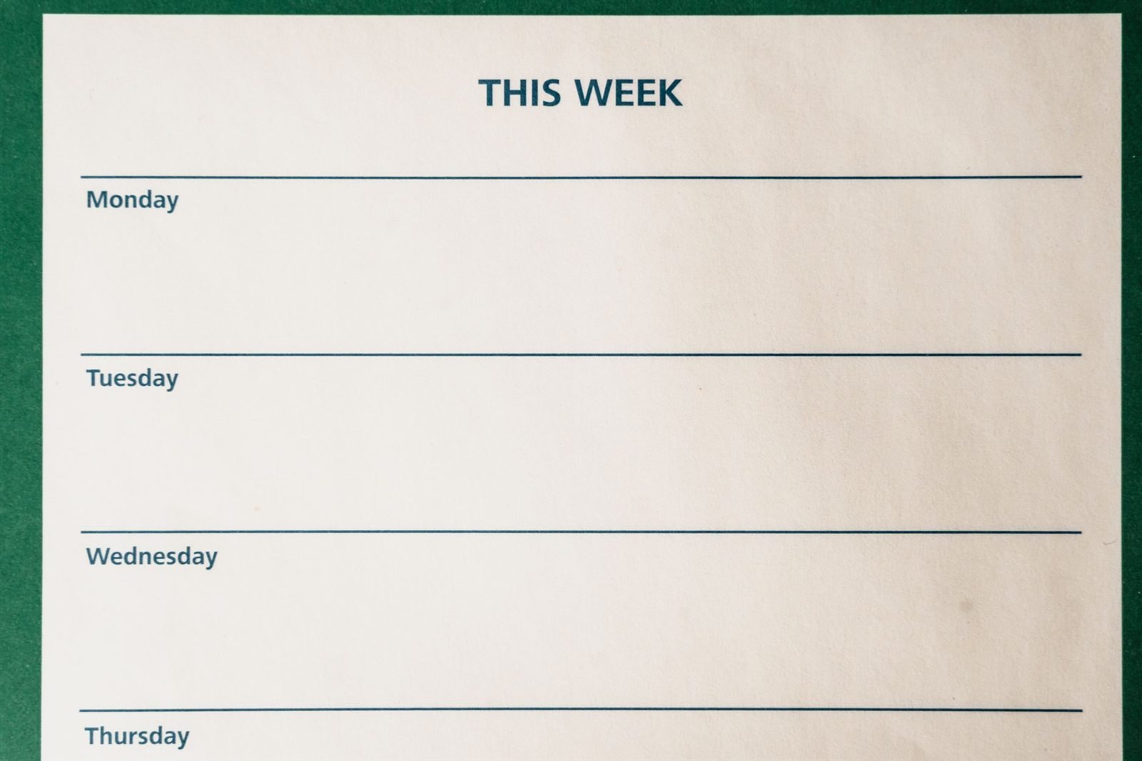 A blank weekly planner page with lines ruled for each day