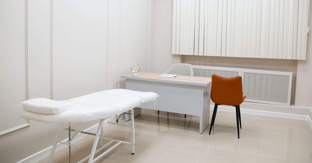 A doctor talking with a patient across a desk